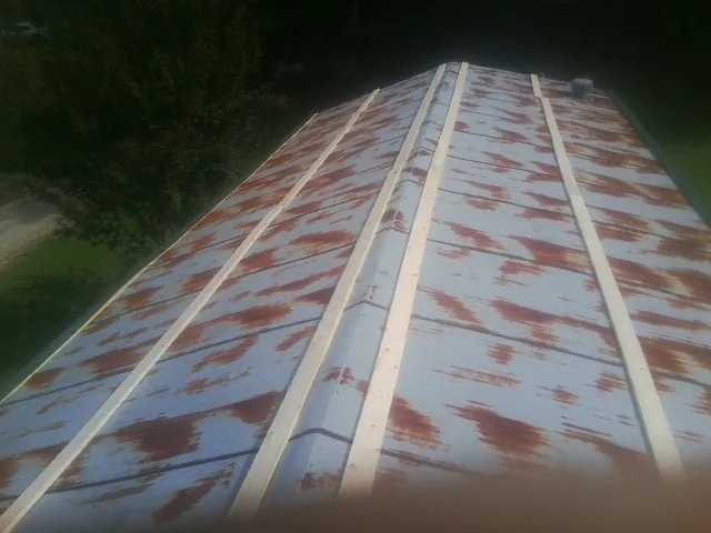 Rusted metal roof panels with new wood purlins before replacement — Storm Damage Roof Repair in Nicollet by Roofing Brothers
