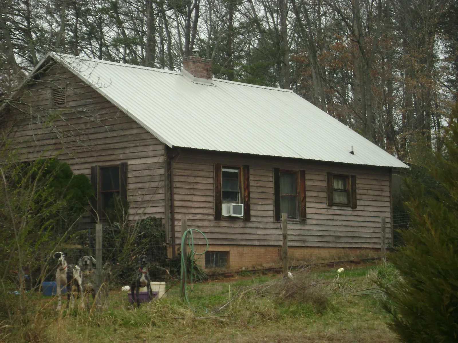 White metal roof on an old wood sided farmhouse, from a Metal Roof Installation job in Nicollet